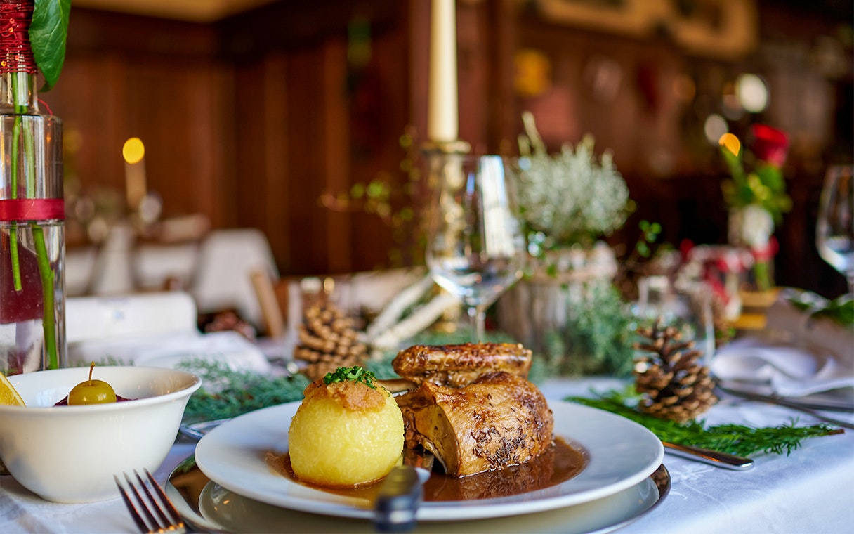 Roast chicken and potato dumpling on a table set for a meal during the Neuschwanstein Castle tour.