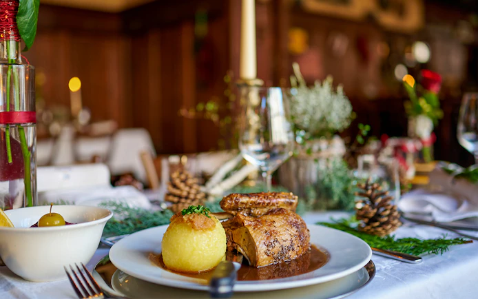 Roast chicken and potato dumpling on a table set for a meal during the Neuschwanstein Castle tour.
