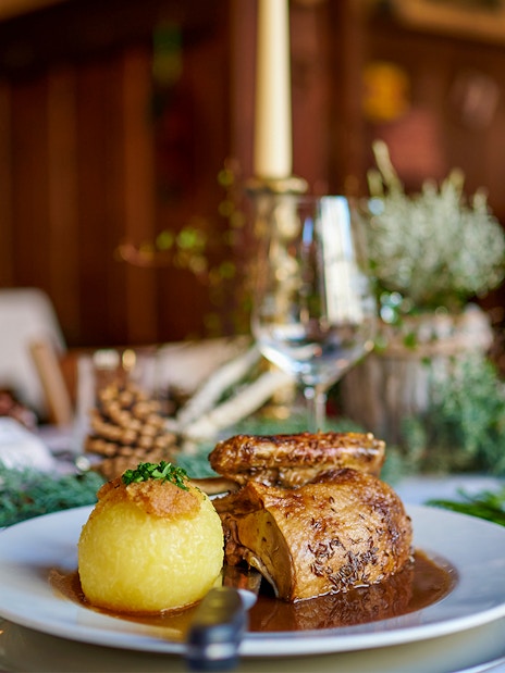 Roast chicken and potato dumpling on a table set for a meal during the Neuschwanstein Castle tour.