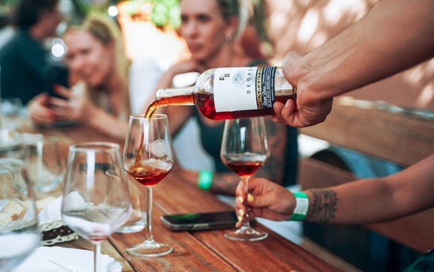 Wine being poured into glasses during Krka National Park tour.