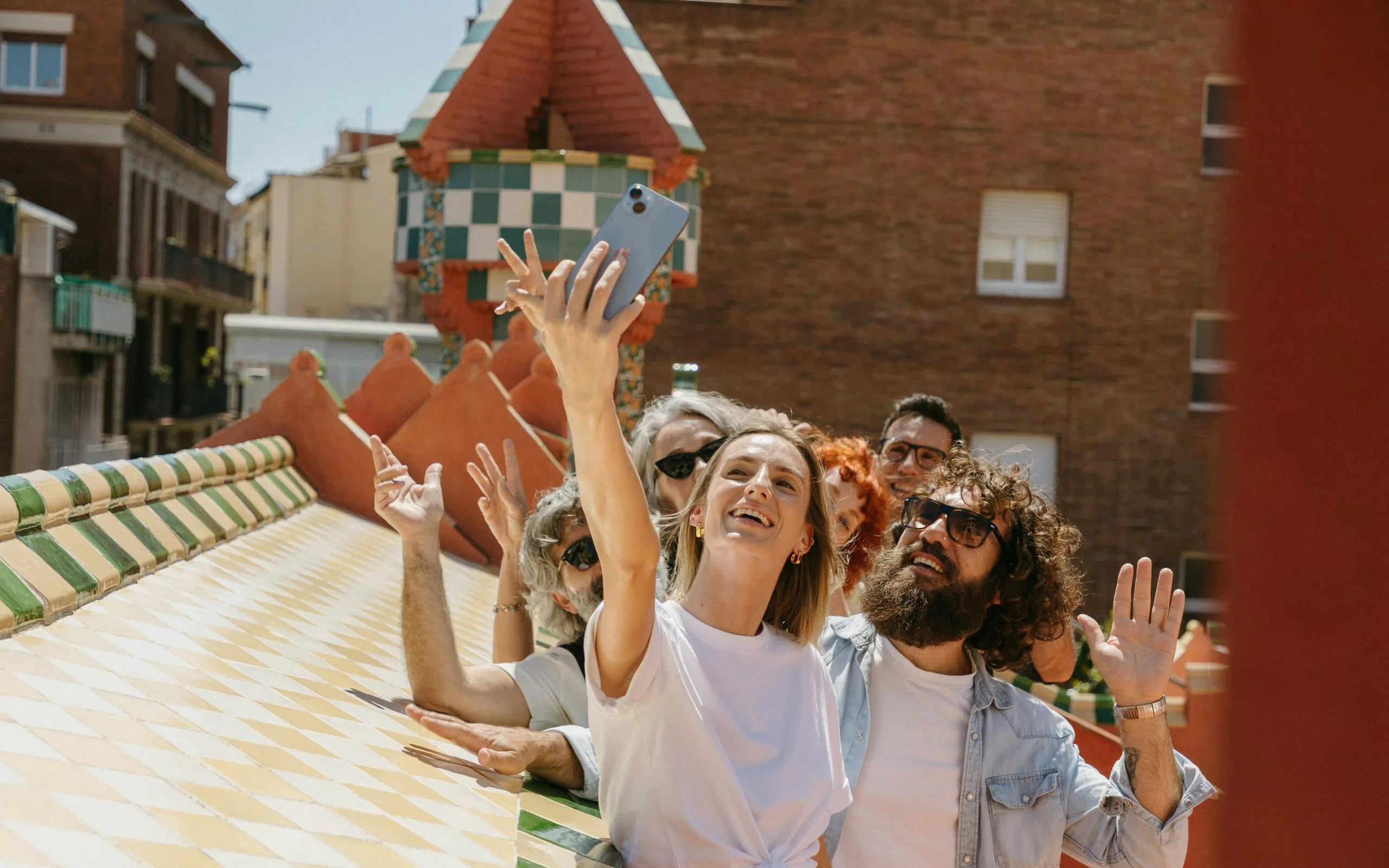 Tourists taking a selfie on Casa Vicens rooftop in Barcelona.