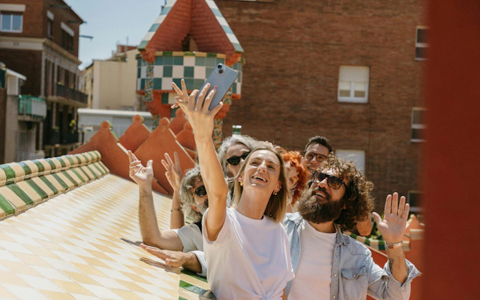 Tourists taking a selfie on Casa Vicens rooftop in Barcelona.