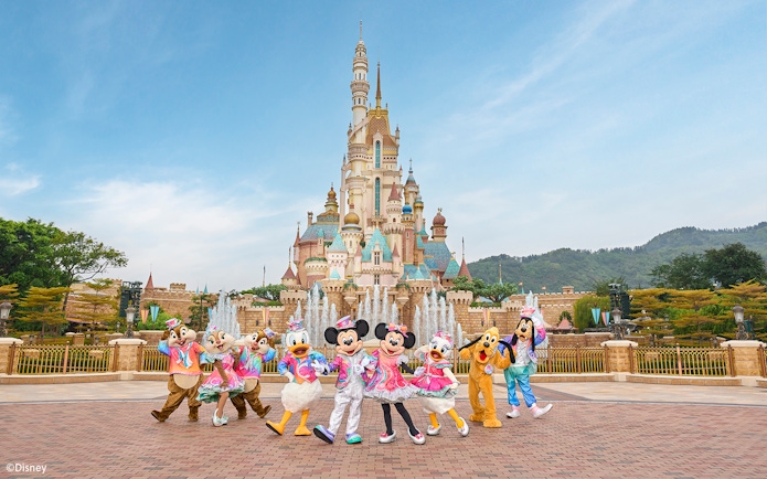 Disney characters celebrating 20th anniversary at Hong Kong Disneyland castle.