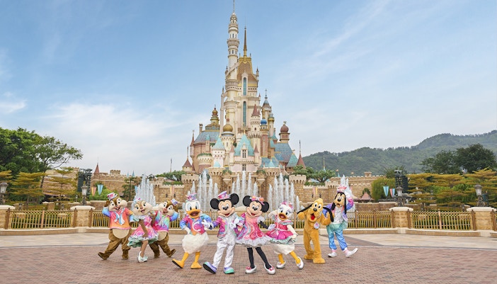 Disney characters celebrating 20th anniversary at Hong Kong Disneyland castle.