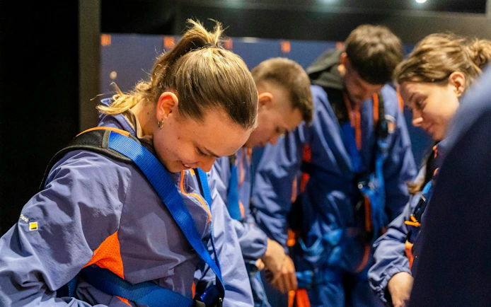 Participants preparing for Adelaide Oval roof climb in safety gear.