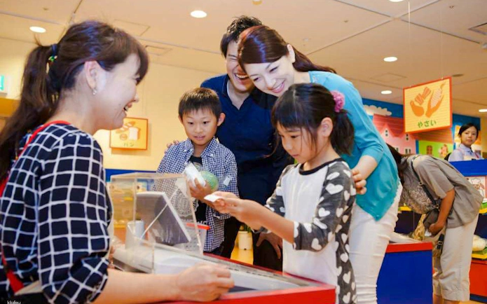 Family enjoying interactive exhibit at Kids Plaza Osaka.