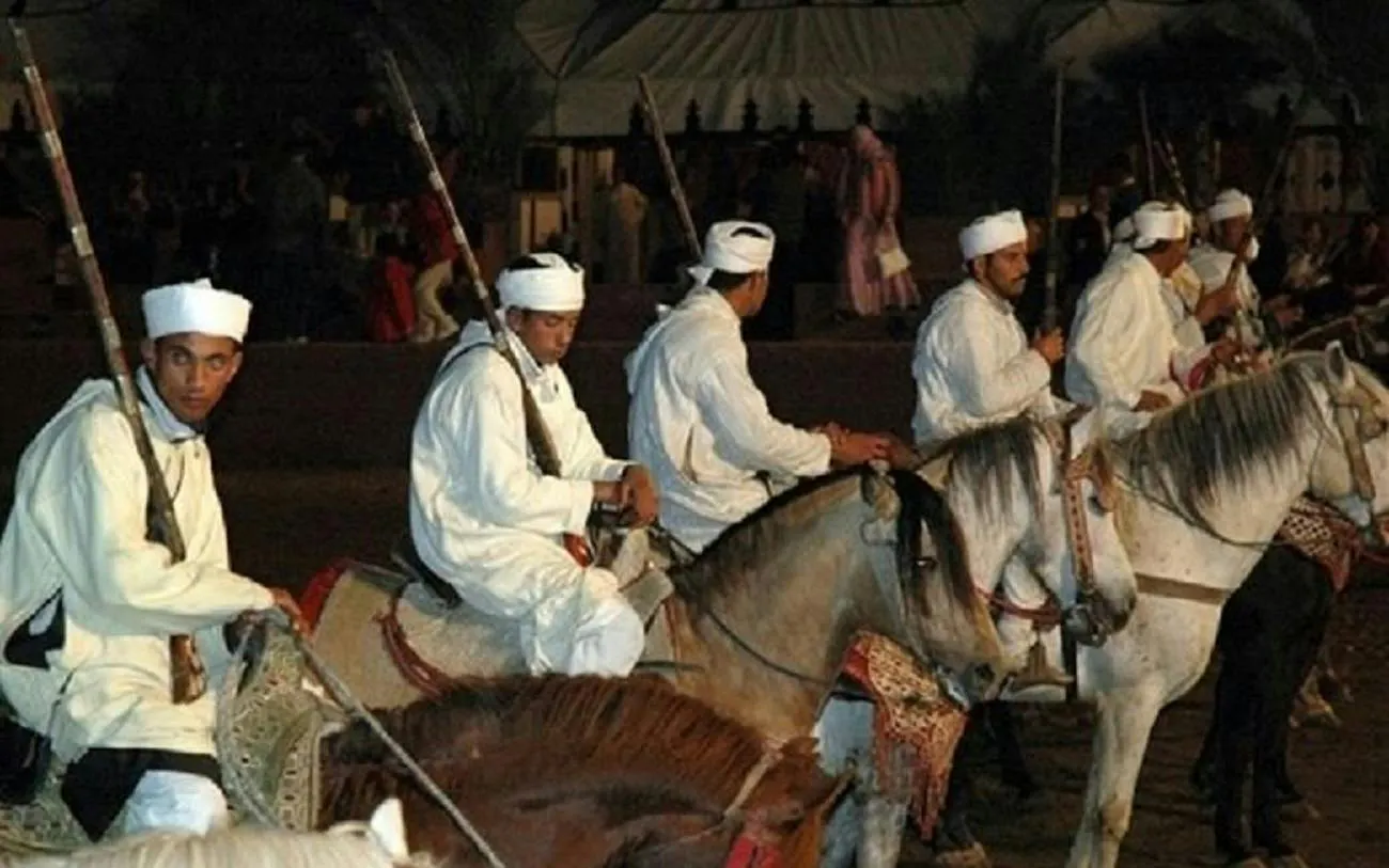 Riders in traditional attire on horses at Chez Ali Fantasia Show, Marrakesh.