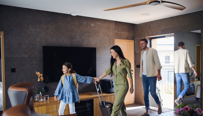 family entering luxury hotel room