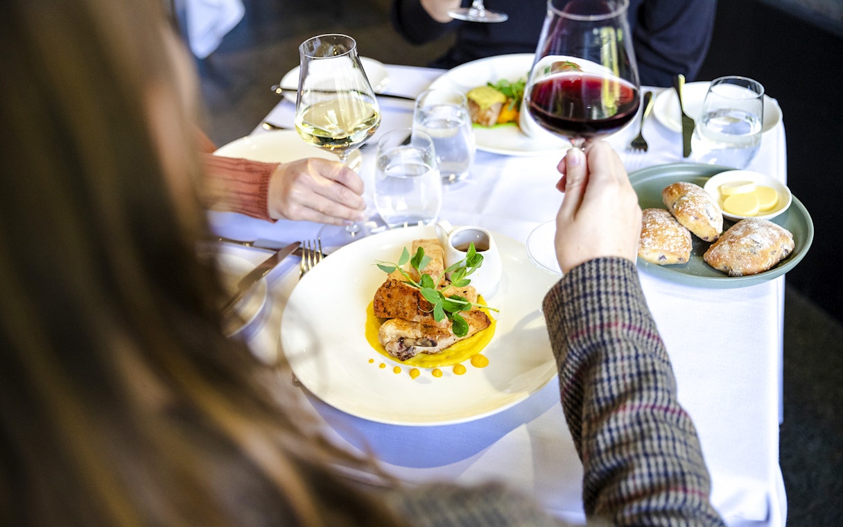 Dining at Garden Restaurant, NGV International, Melbourne with wine and gourmet dishes.