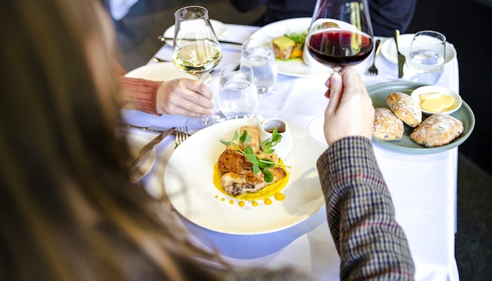 Dining at Garden Restaurant, NGV International, Melbourne with wine and gourmet dishes.