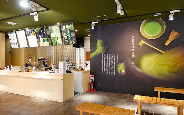 Tea shop interior in Tokyo with matcha-themed decor, part of Panoramic Tokyo 1 Day Bus Tour.