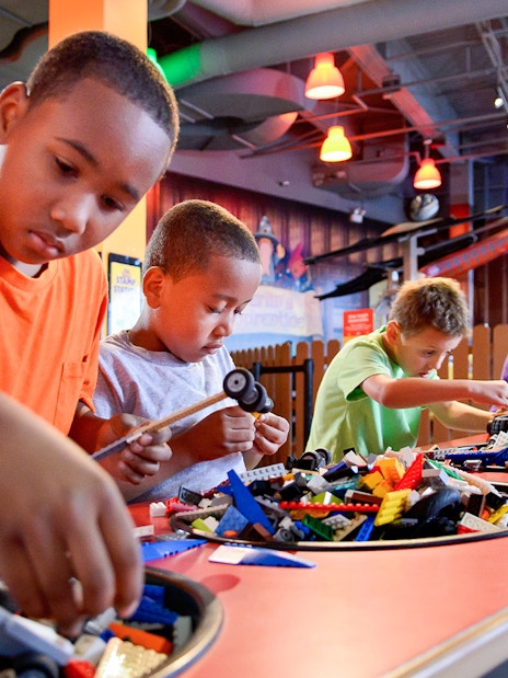 Children building with LEGO bricks at a Chicago attraction.