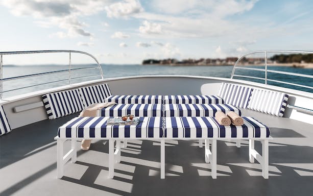 Striped lounge chairs on a boat deck during Palma Bay tour.