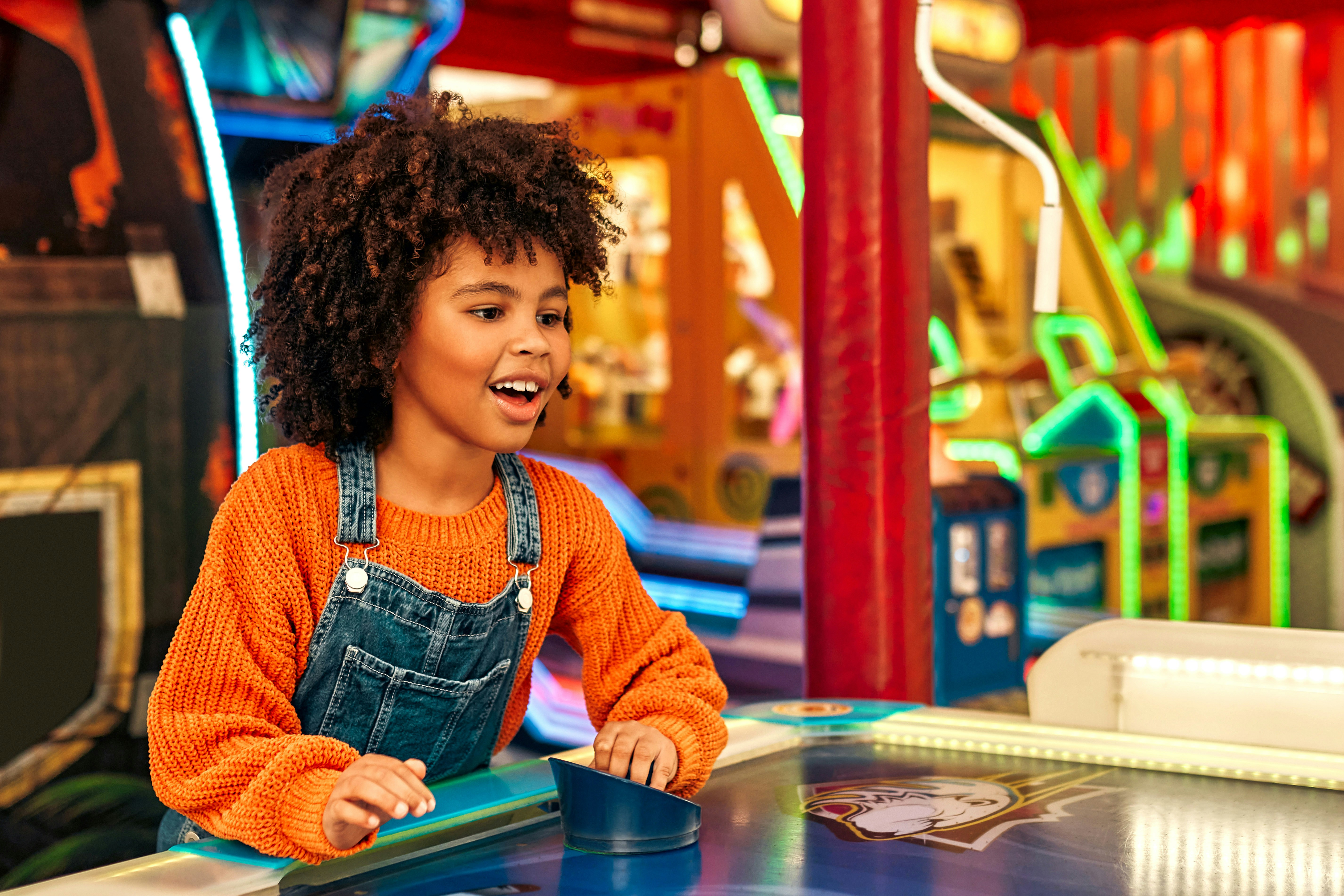 Child enjoying an arcade game at Wonderworks Orlando.