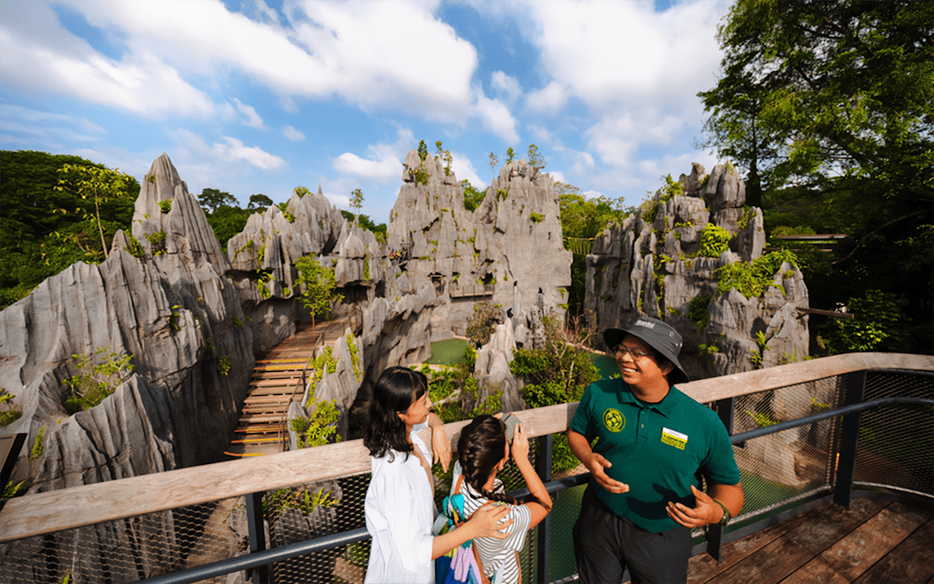 Ranger explaining karst formations to visitors on a scenic overlook.