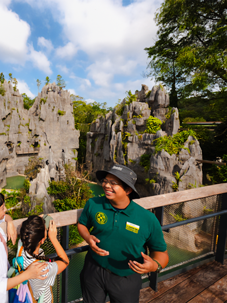 Ranger explaining karst formations to visitors on a scenic overlook.