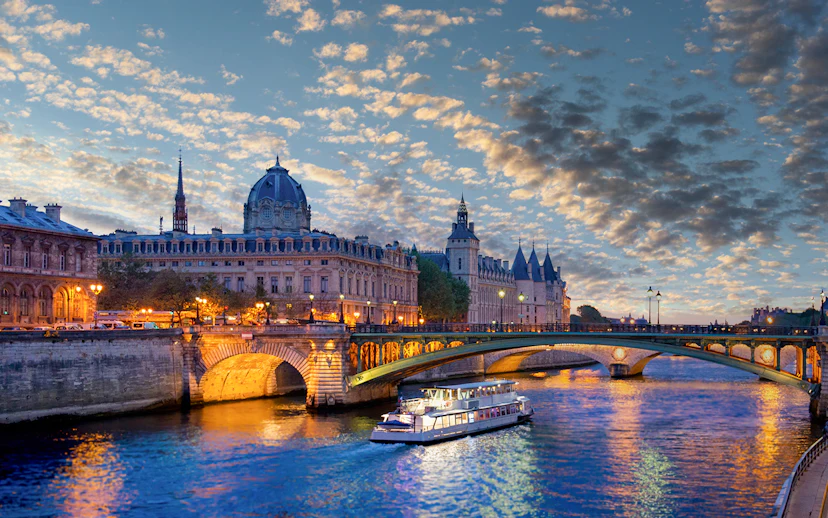 Conciergerie Museum and Seine River at sunset in Paris.