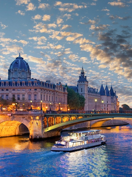 Conciergerie Museum and Seine River at sunset in Paris.