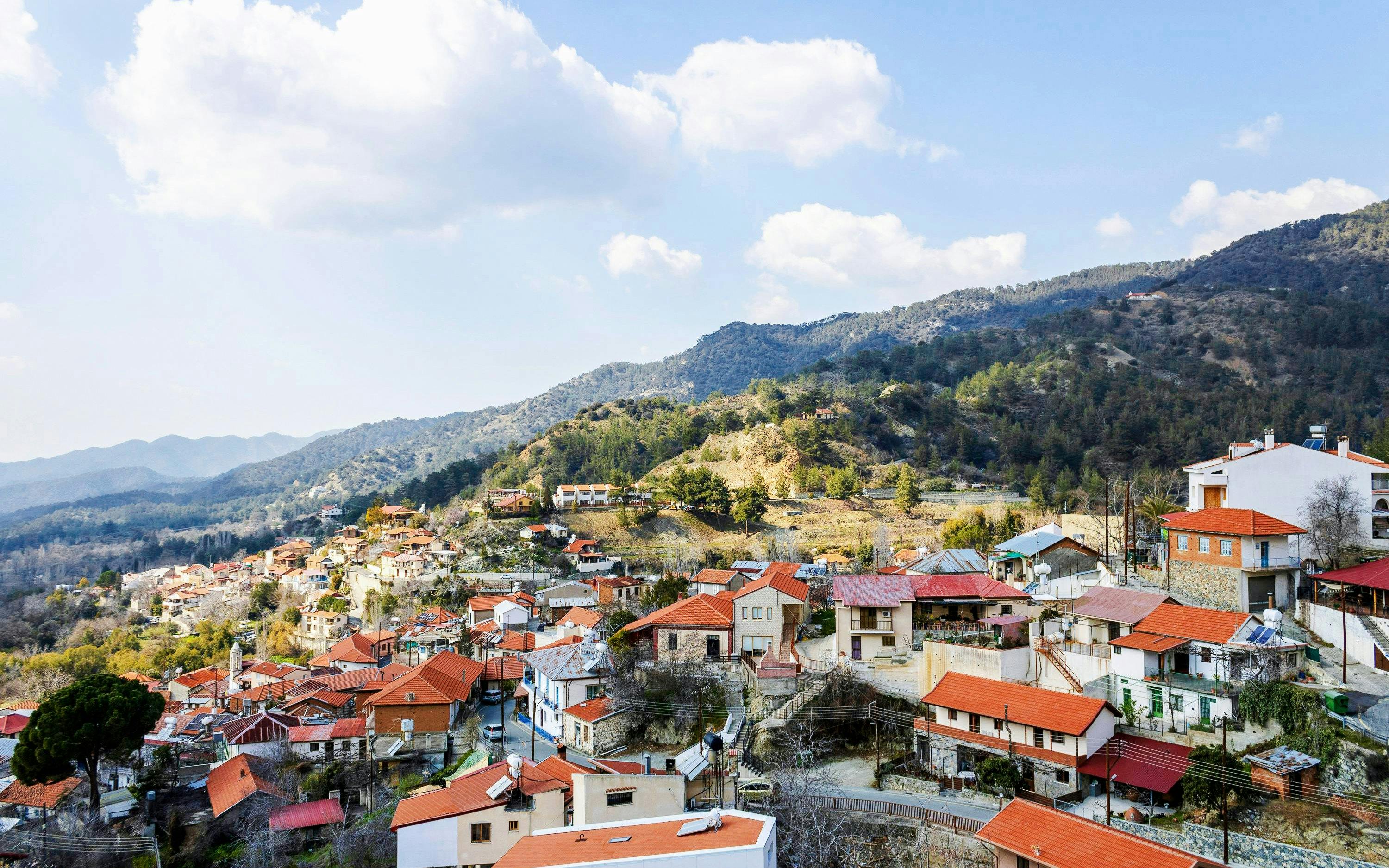 Panoramic view of Foini village with red-roofed houses in Troodos Mountains, Cyprus.