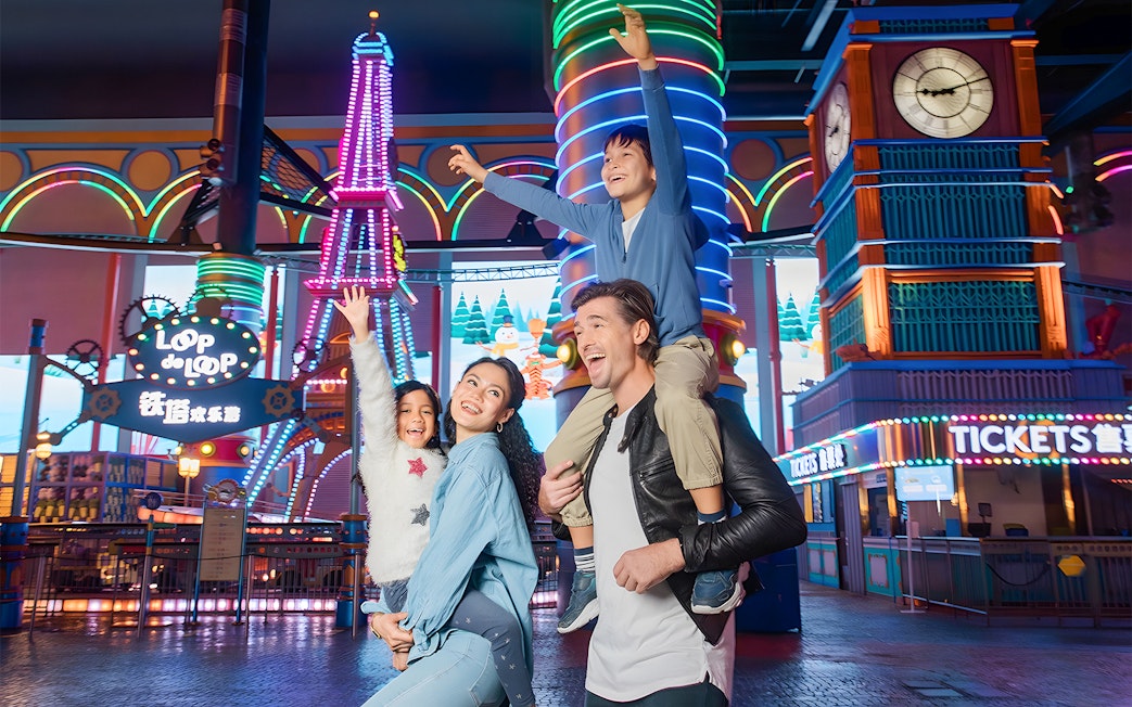 Family enjoying rides at Genting Skytropolis Indoor Theme Park, Malaysia.
