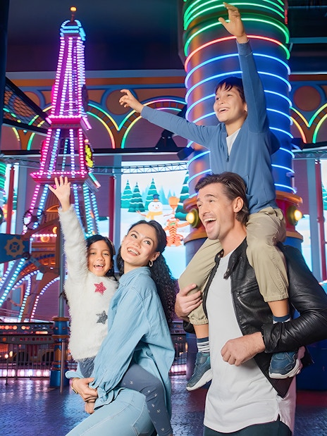Family enjoying rides at Genting Skytropolis Indoor Theme Park, Malaysia.