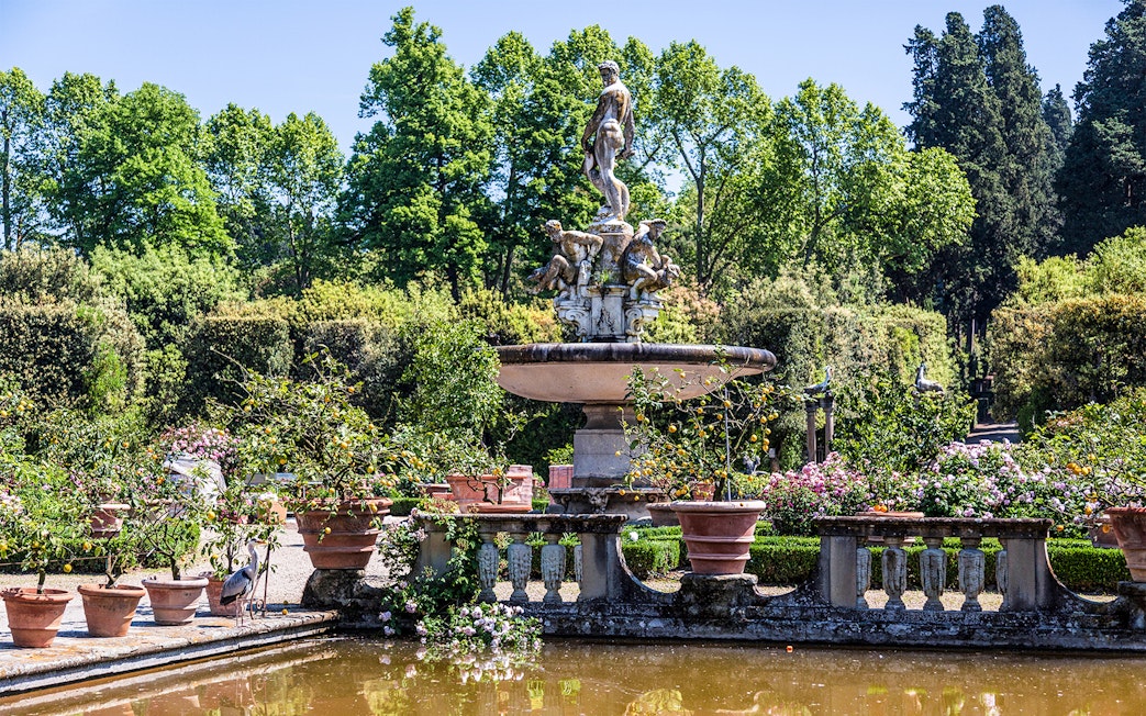 Fountain with statues surrounded by greenery in Boboli Gardens, Florence.