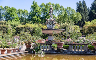 Fountain with statues surrounded by greenery in Boboli Gardens, Florence.