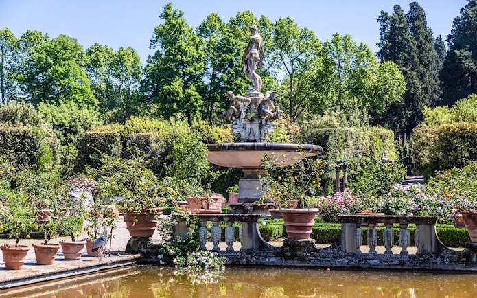 Fountain with statues surrounded by greenery in Boboli Gardens, Florence.