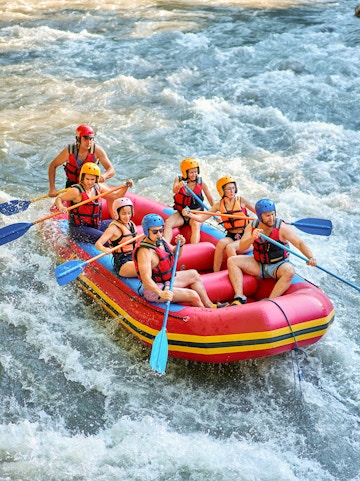 Rafting group navigating rapids on Barron River, Cairns.