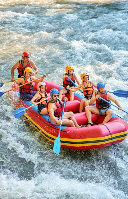 Rafting group navigating rapids on Barron River, Cairns.
