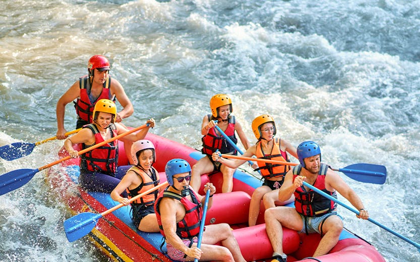 Rafting group navigating rapids on Barron River, Cairns.