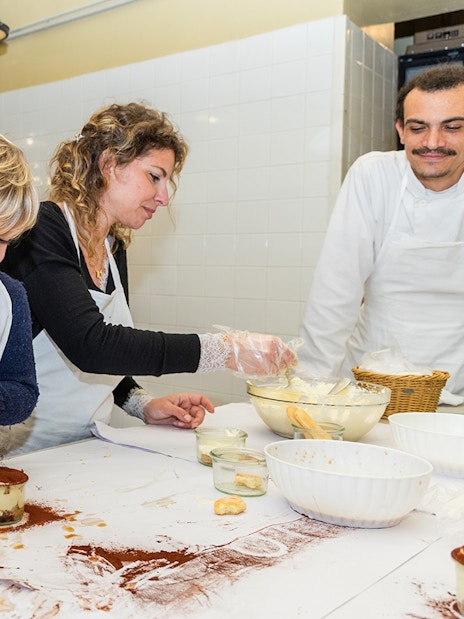 Kids making tiramisu in a Rome cooking class kitchen.