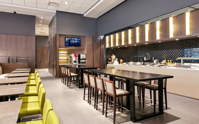 Plaza Premium Lounge seating and buffet area at Vancouver International Airport (YVR) Domestic Departures.