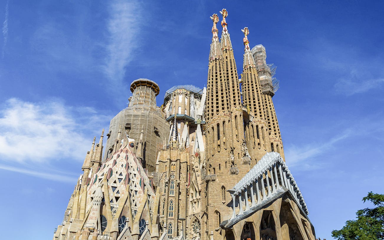 Sagrada Familia towers against blue sky in Barcelona.
