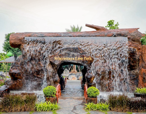 Sri Ayutthaya Lion Park entrance with traditional Thai architecture and lion statues, Thailand.