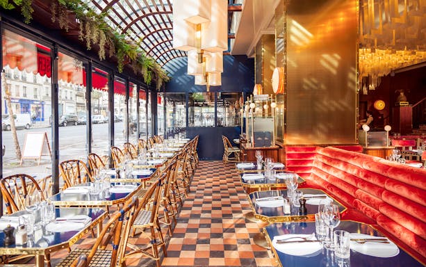 Opulent dining area at Opéra-Grand Café Capucines, Paris, with elegant table settings.
