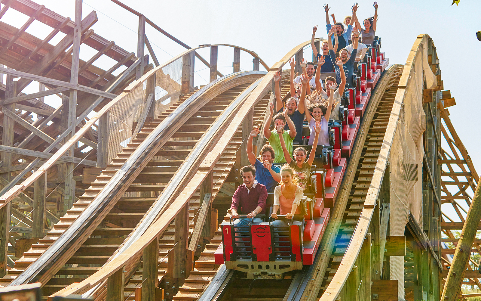 Stampida wooden roller coaster at PortAventura Park, Spain, with blue sky backdrop.