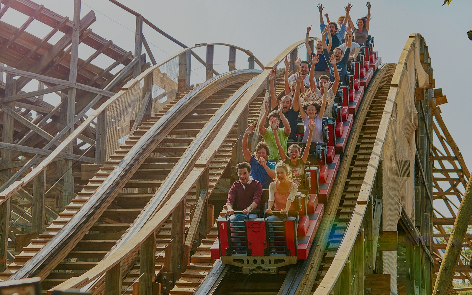 Stampida wooden roller coaster at PortAventura Park, Spain, with blue sky backdrop.