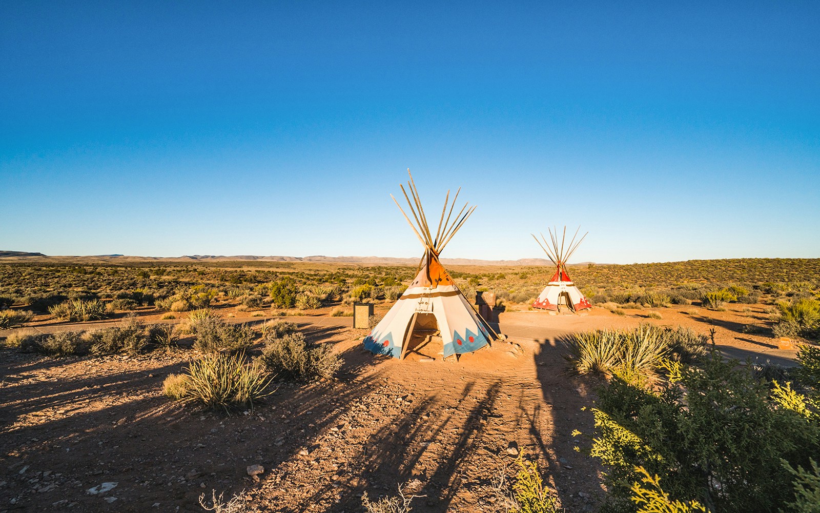 Tribal tents at West Rim, Grand Canyon, Arizona with scenic canyon backdrop.