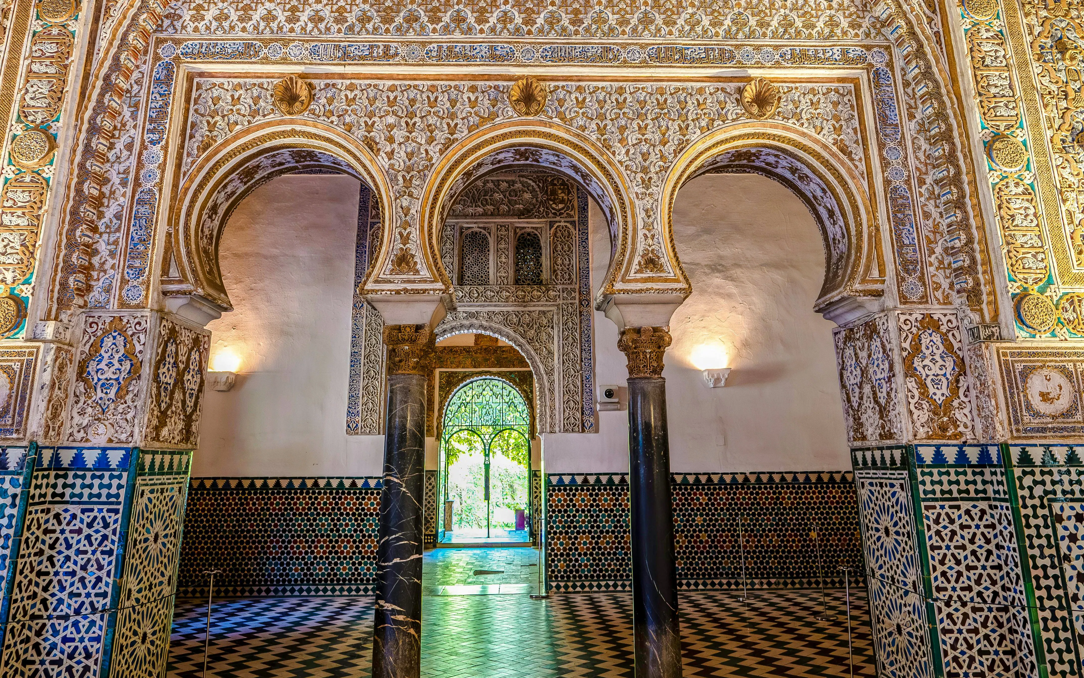 Mudejar arches and intricate tilework in the Salón de los Embajadores, Seville.