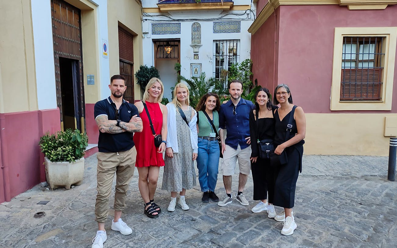 Group of tourists on a guided Jewish Quarter discovery walk in a historic neighborhood.