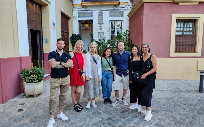 Group of tourists on a guided Jewish Quarter discovery walk in a historic neighborhood.