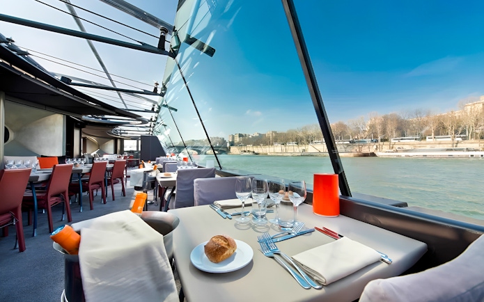 Bateaux Parisiens lunch cruise table setting with Seine River view in Paris.