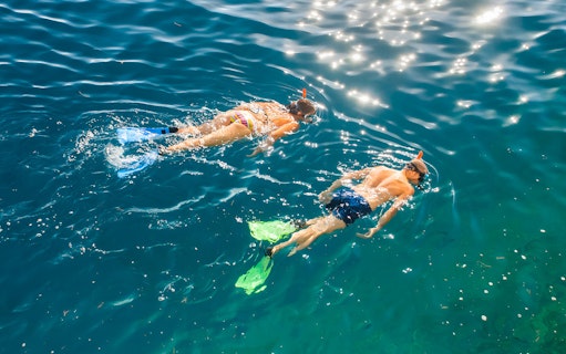 Snorkelers exploring clear waters on Betina Cave Beach tour.