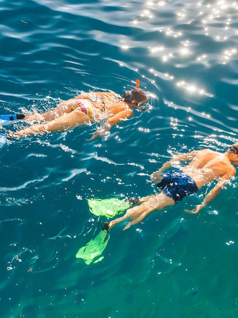 Snorkelers exploring clear waters on Betina Cave Beach tour.