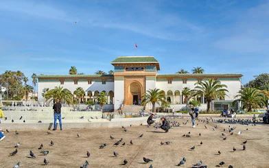 Palace of Justice on Mohammed V Square, Casablanca, with people and pigeons in the foreground.