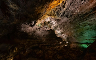 Cave interior with illuminated rock formations in Cueva de los Verdes, Lanzarote.