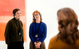 Visitors enjoying an audio-guided tour at the National Gallery of Victoria.