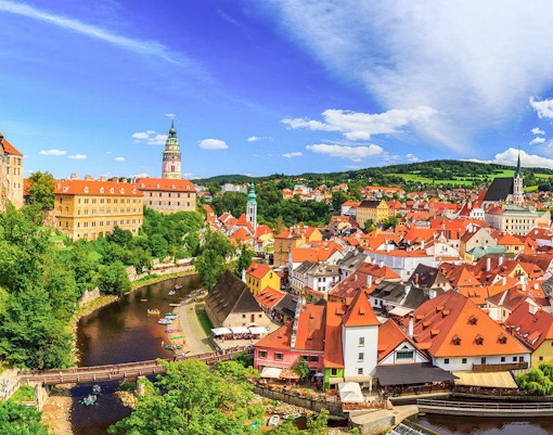 Aerial view of Cesky Krumlov's historic town center with Vltava River winding through.