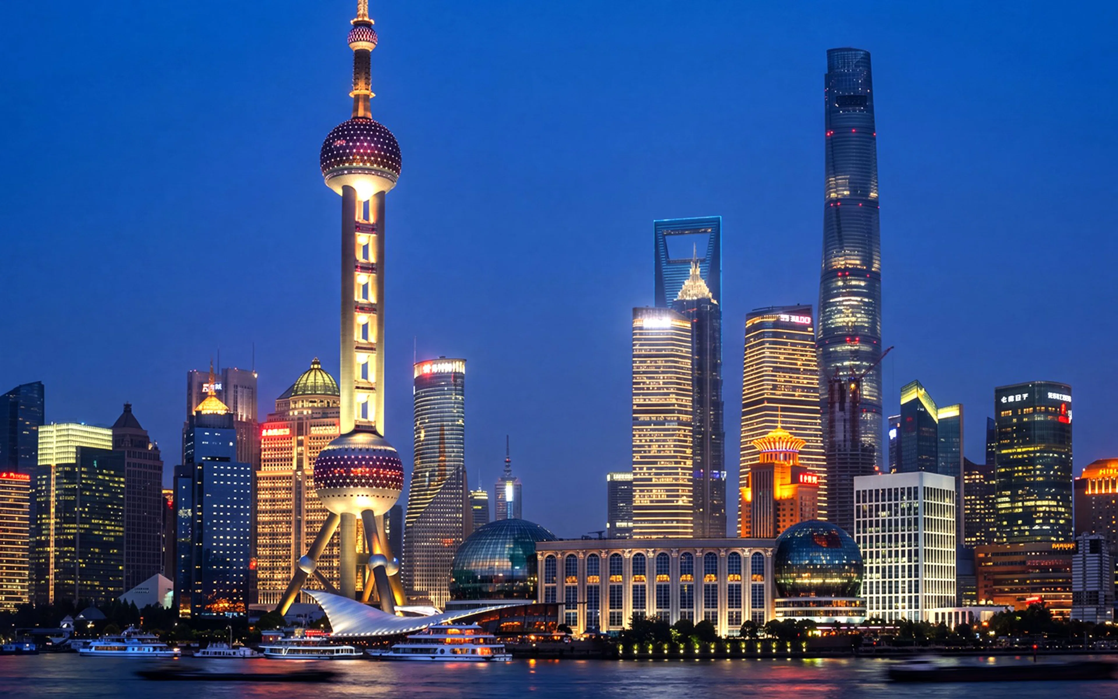 Oriental Pearl Tower illuminated at night in Pudong, Shanghai, viewed from across the Huangpu River.